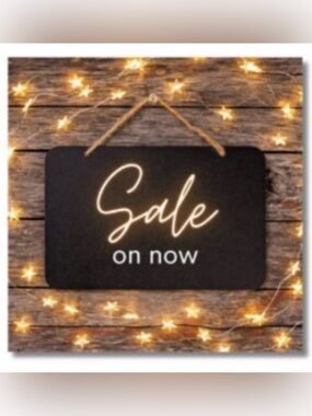 Black Hanging 'Sale on now' Sign with Warm String Lights